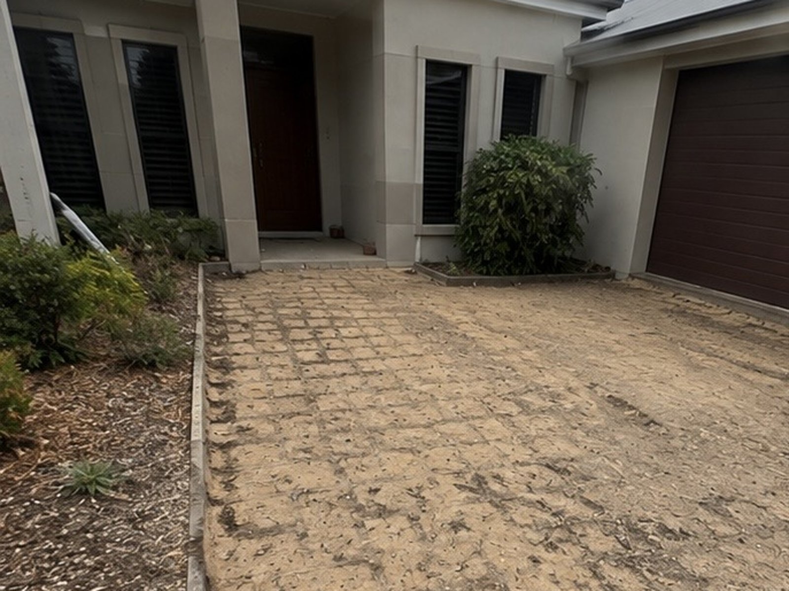 Front driveway and entry path with pavers removed down to the sand base