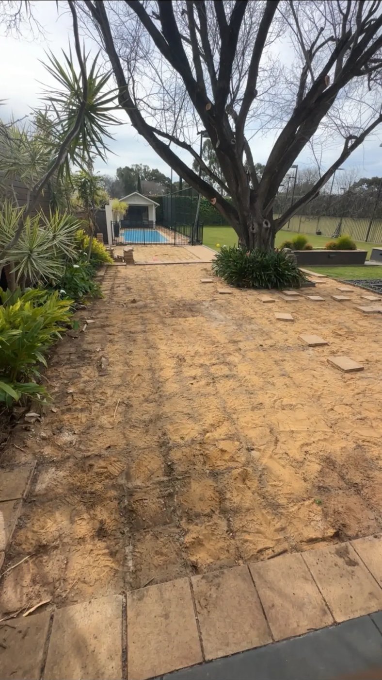 Backyard poolside area with pavers stacked for collection